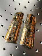 Two brass 1911 gun grips with a crusader design 