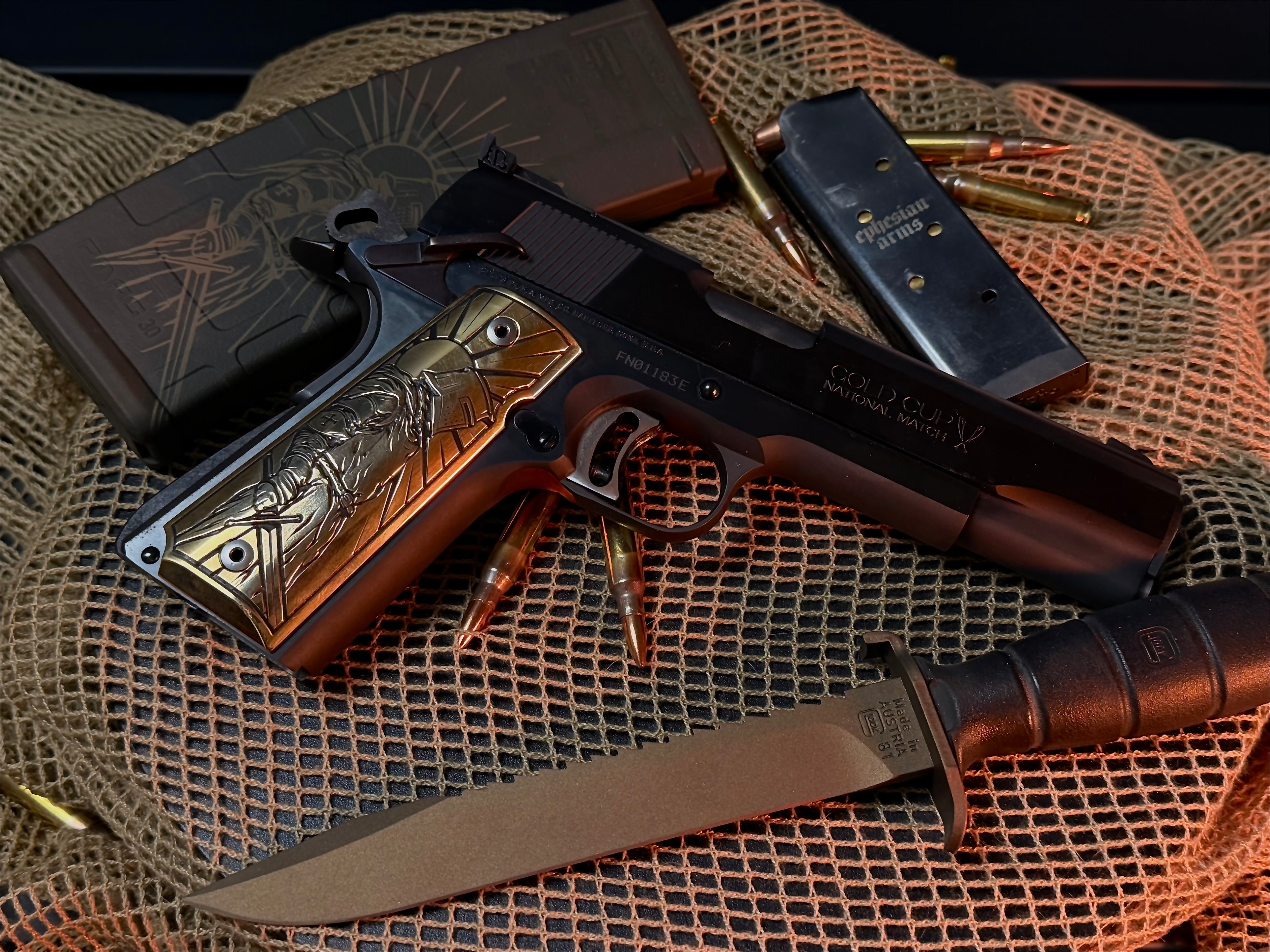 Custom 1911 with laser engraved brass grip, glock knife, and ammunition on a textured surface