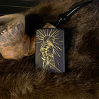 Black lighter with gold design on a fur surface