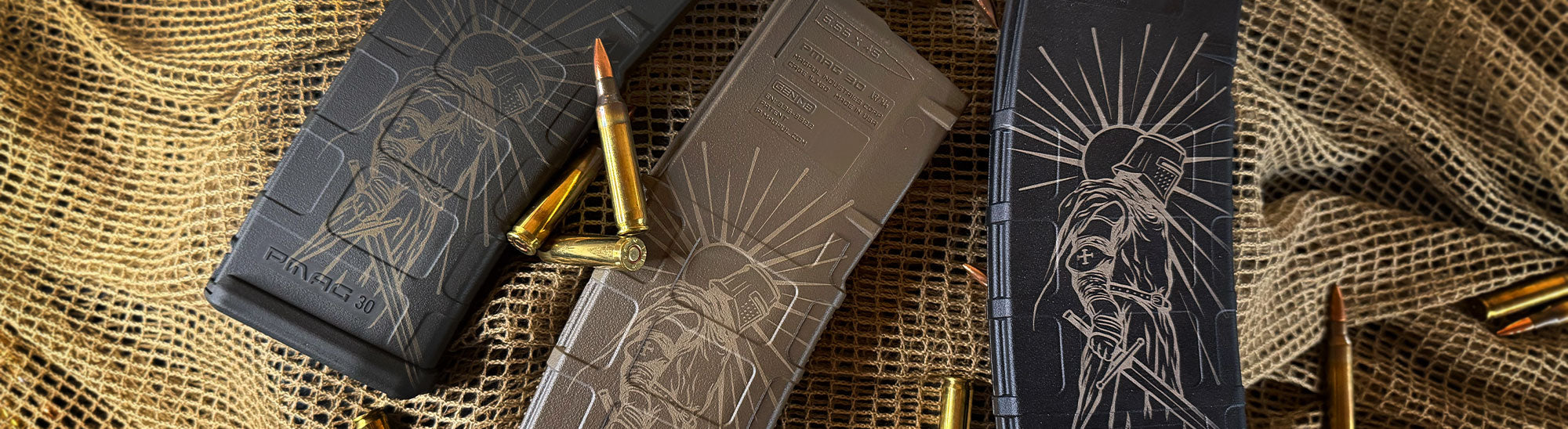 Three Cerakote laser engraved Crusader AR magazines on a net with bullets around them.