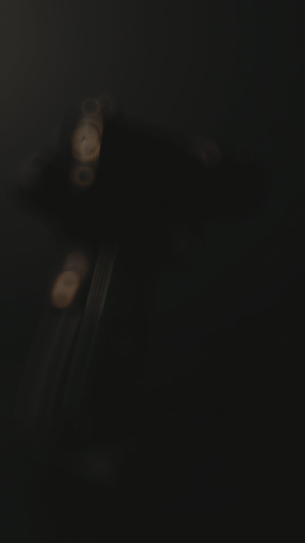 Custom 1911 aluminum gun grips with engraved crusader designs on a textured surface.