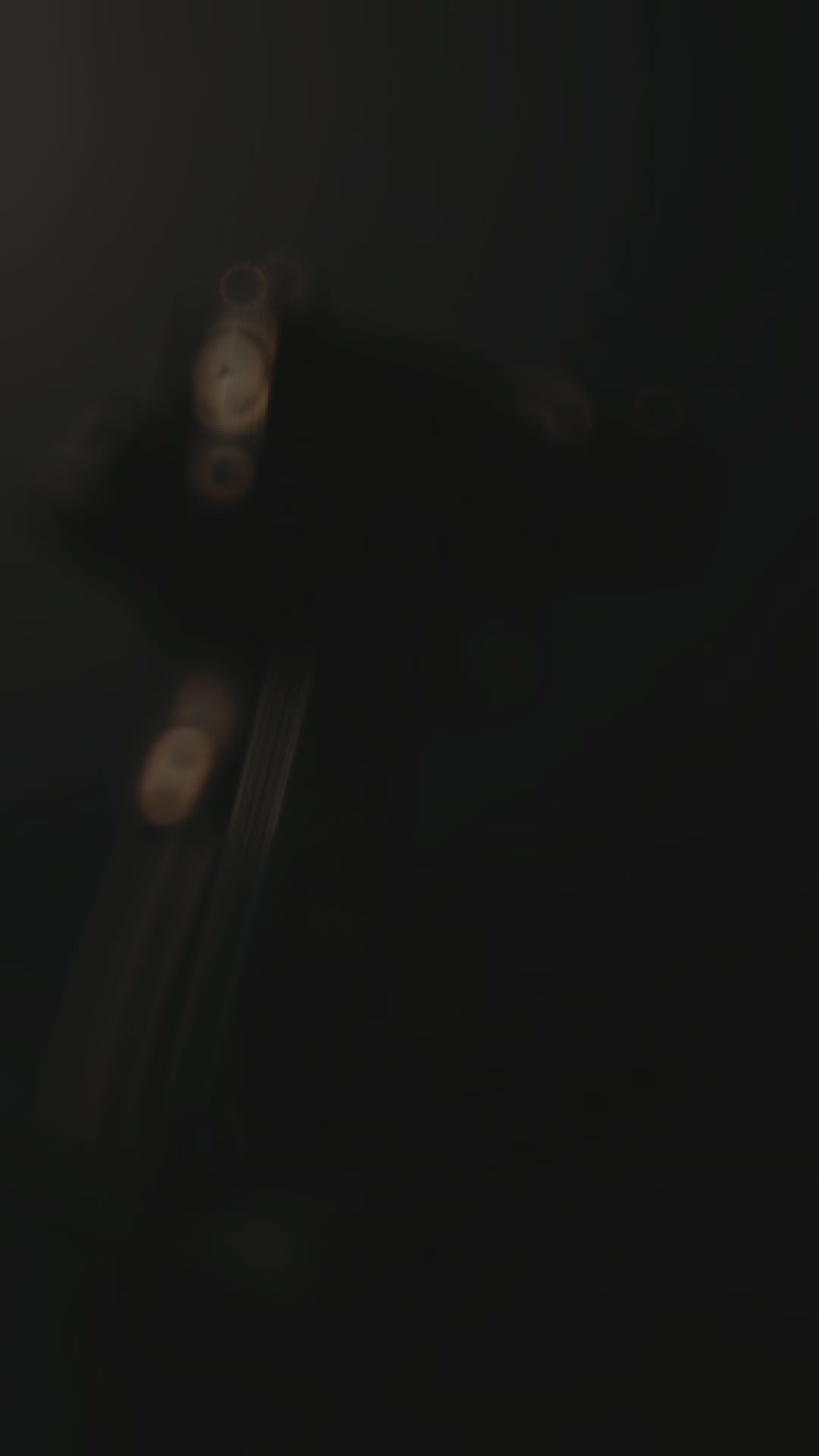 Custom 1911 aluminum gun grips with engraved crusader designs on a textured surface.