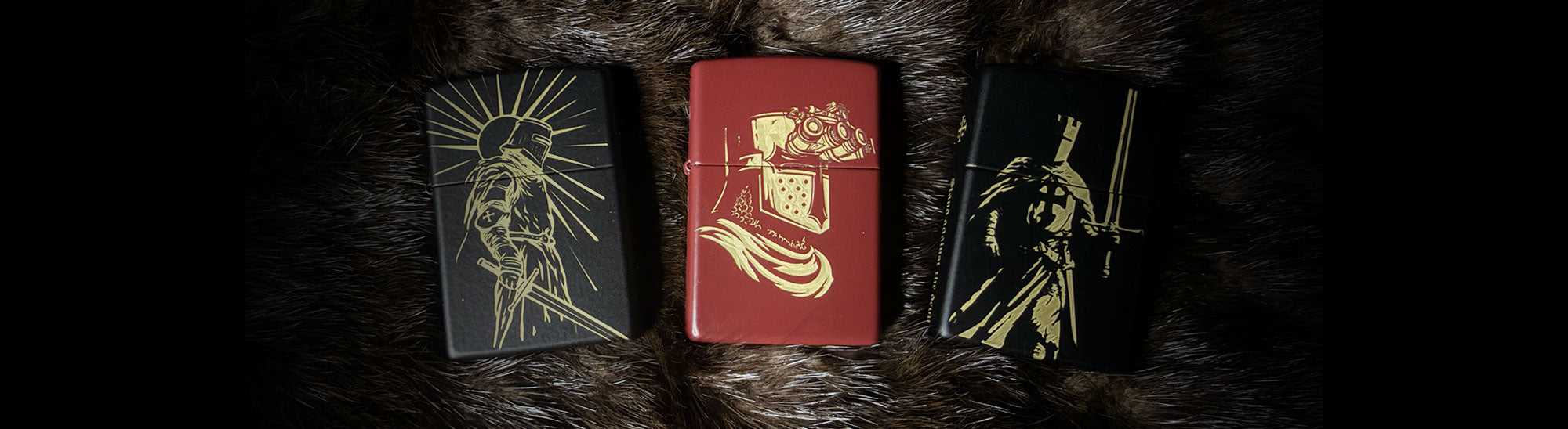 Three decorative laser engraved crusader zippos with gold designs on a dark fur background